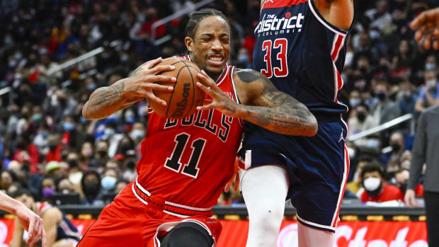 Jan 1, 2022; Washington, District of Columbia, USA; Chicago Bulls forward DeMar DeRozan (11) drives as Washington Wizards forward Kyle Kuzma (33) defends during the second half at Capital One Arena. Mandatory Credit: Brad Mills-USA TODAY Sports